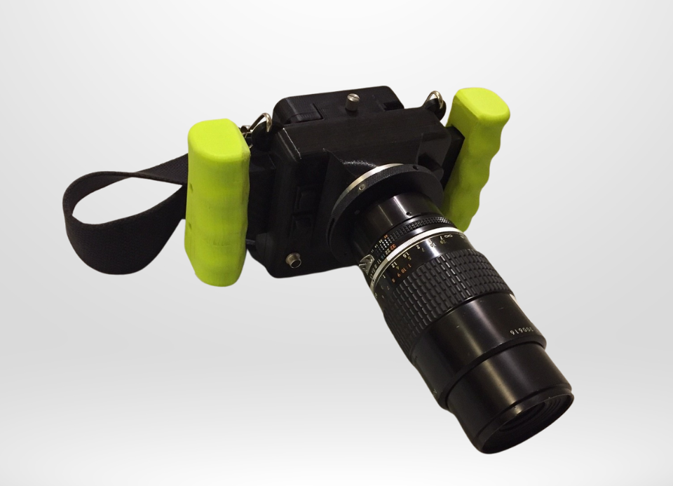CRIS II cerenkov viewing device with black body, mounted nikon lens, green ergonomic handles and neck strap.